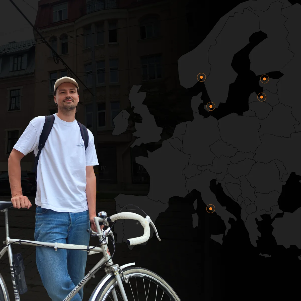 Ēriks with his bike, beside a map of Europe marking cities he's worked with startups in